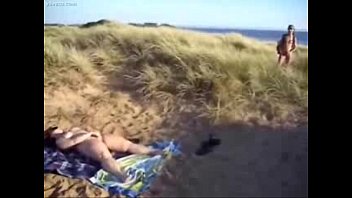 Horny slut loves to be watched while she masturbates at beach