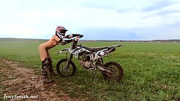 Naked woman riding a Dirt Bike